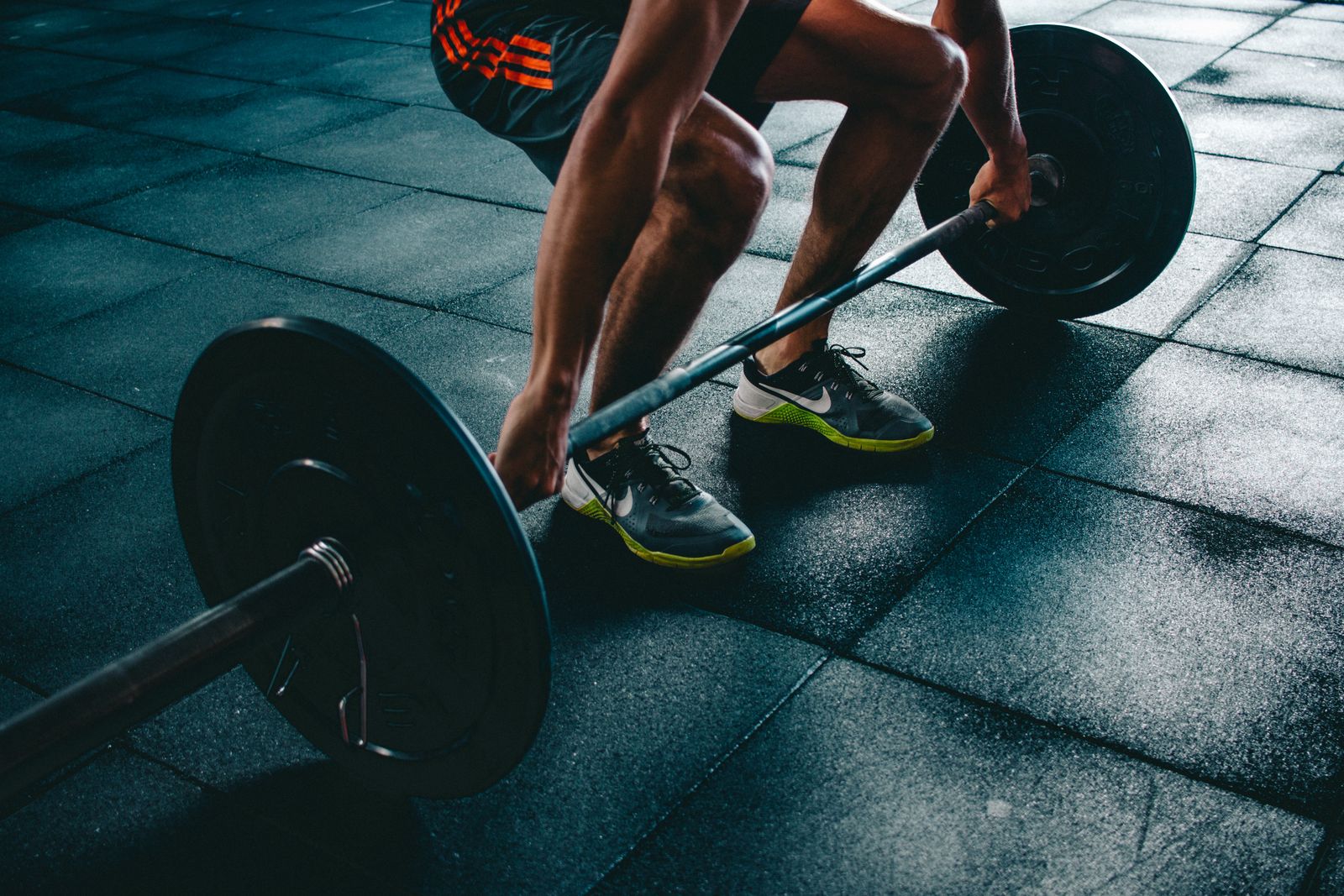 Athlete setting up a barbell deadlift in the gym